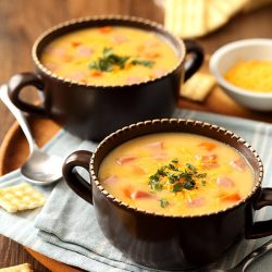 two bowls of ham and cheese soup