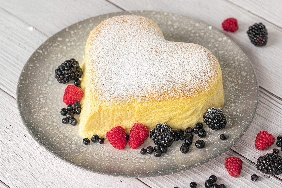 overhead of heart shaped cheesecake with powdered sugar 