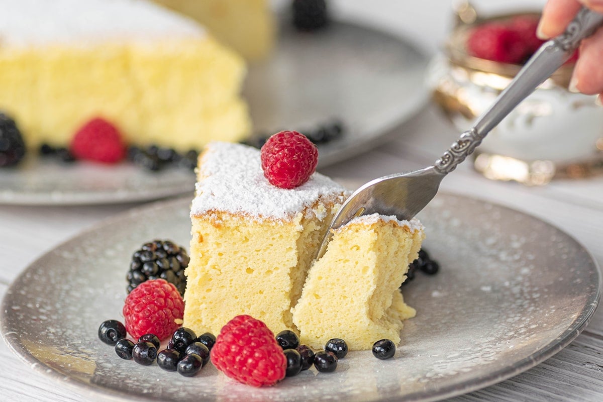 fork digging into slice of cheesecake 