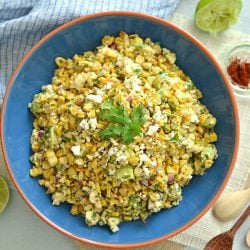 overhead of esquites in a blue bowl