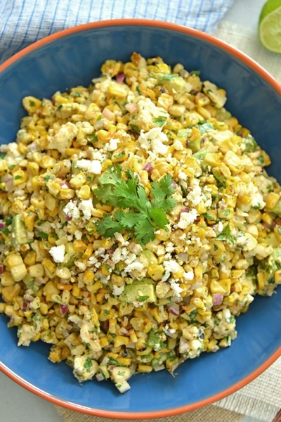 overhead of esquites in a blue bowl