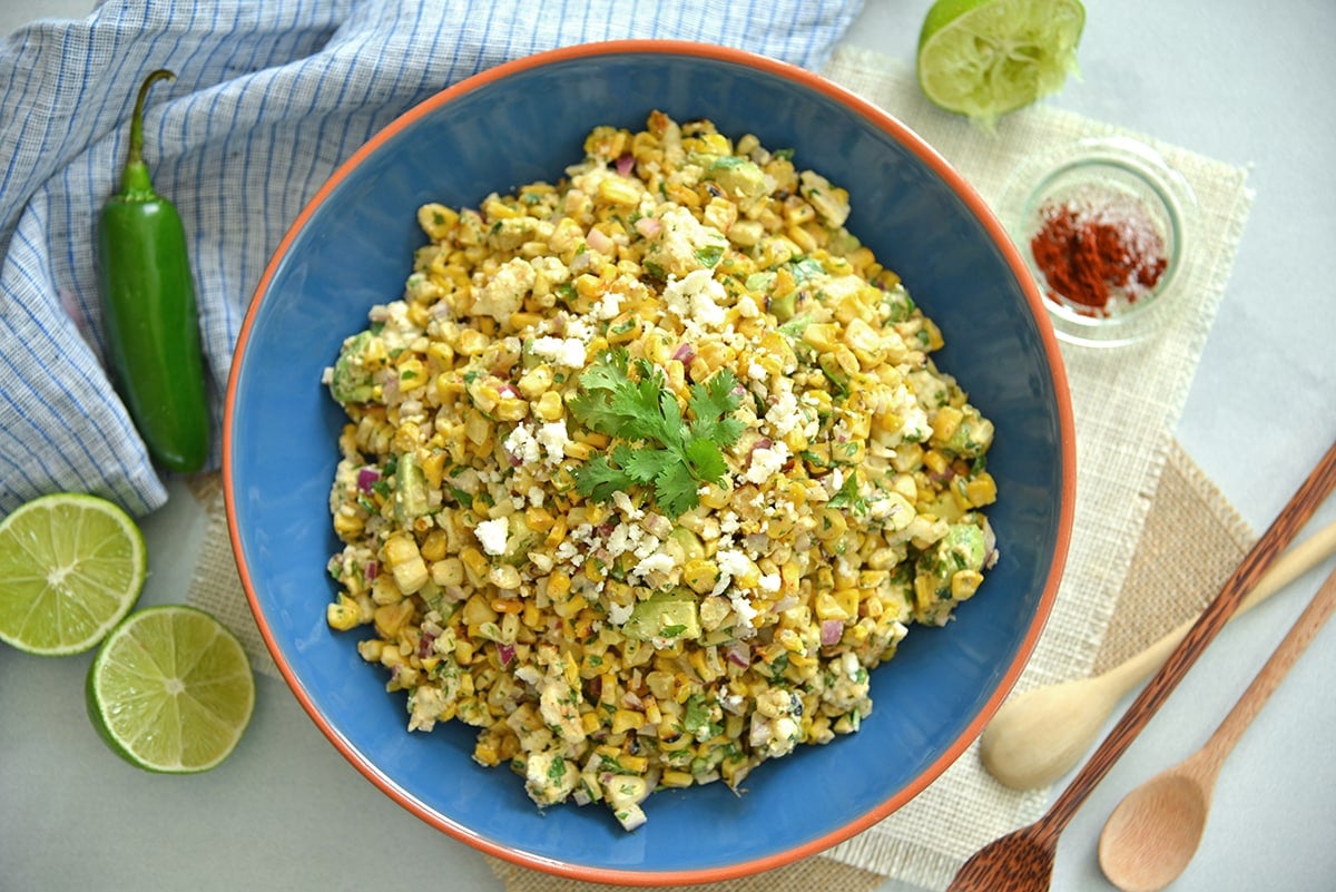 overhead of esquites in a blue bowl