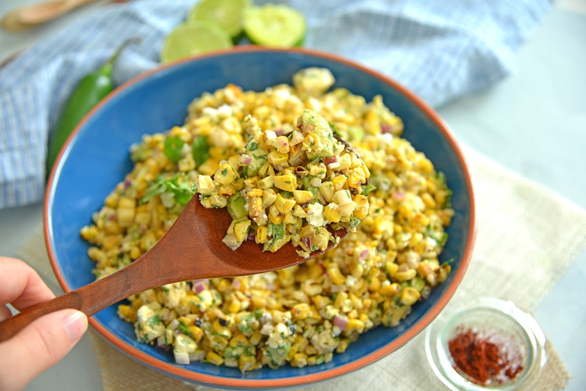 corn salad on a wooden spoon