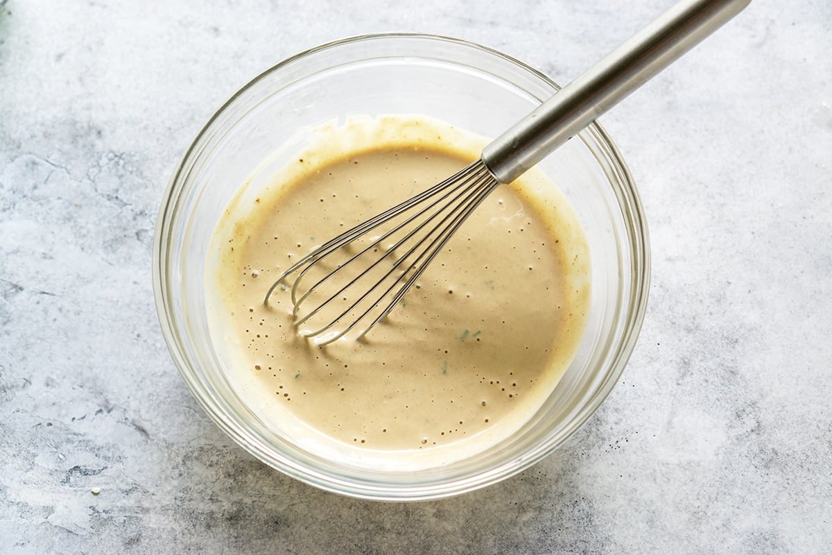 whisking together remoulade sauce 