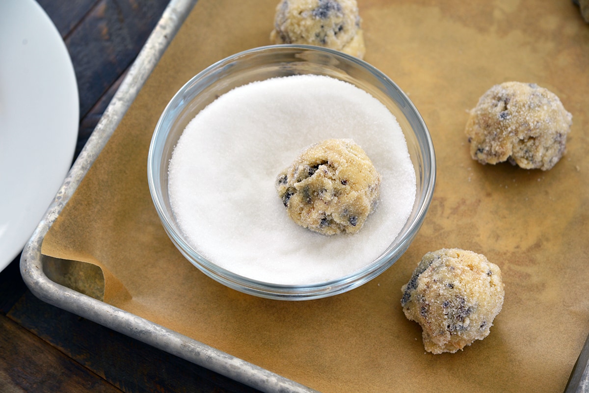 cookie dough in a bowl of white sugar 