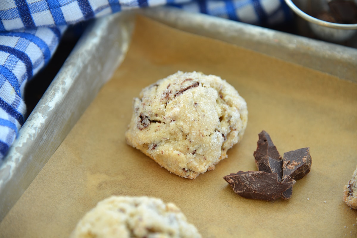 cookie dough coated in sugar on a baking sheet 