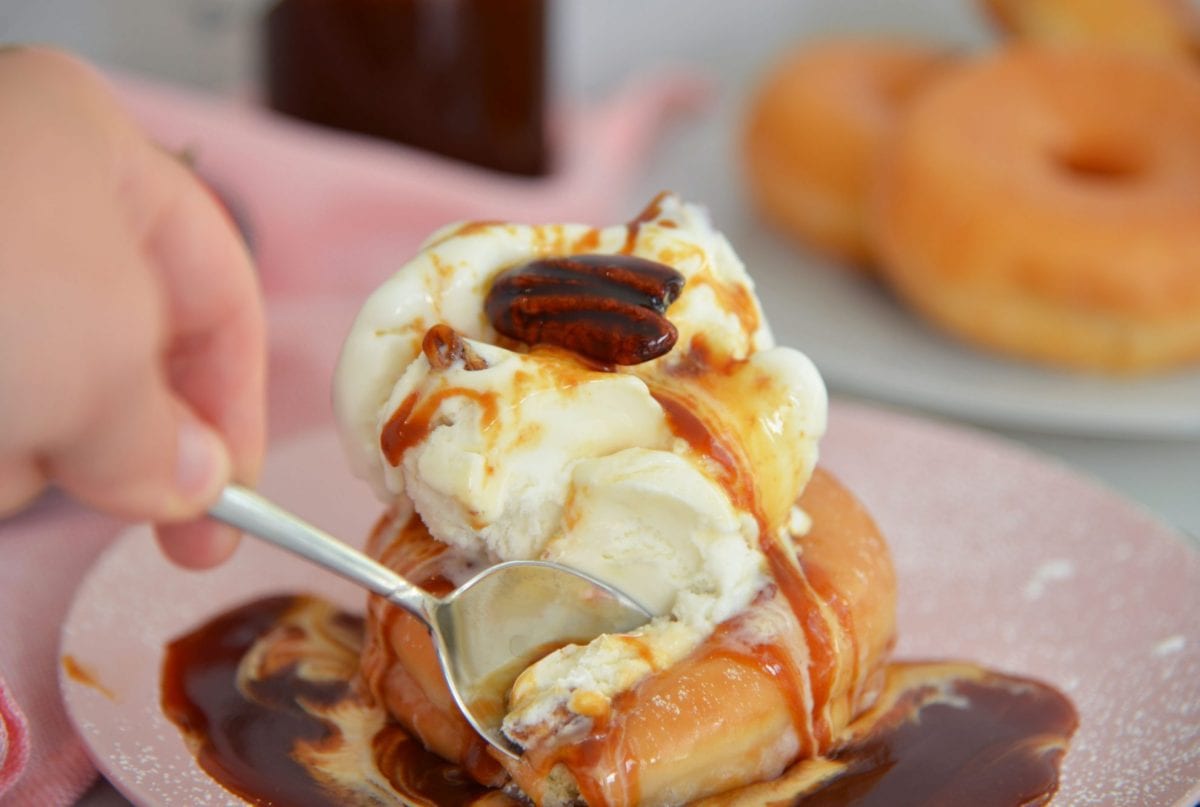 spoon digging into ice cream sundae 