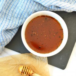 overhead of hot honey in a small white bowl