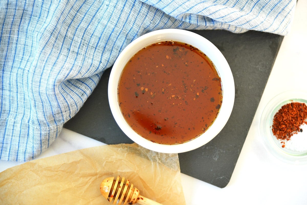 overhead of hot honey in a small white bowl