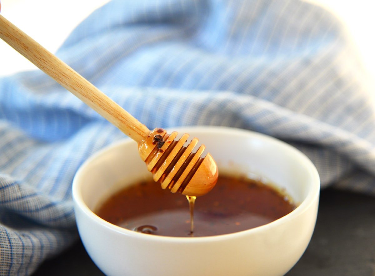 honeycomb dipping into bowl of hot honey