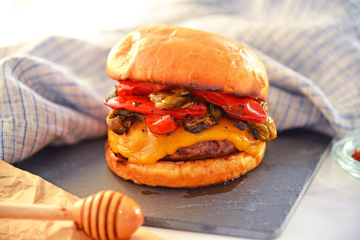 hot honey hamburger with cheese on a slate serving dish 