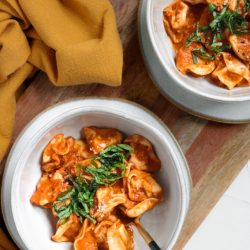 overhead shot of two bowls of tortellini pasta