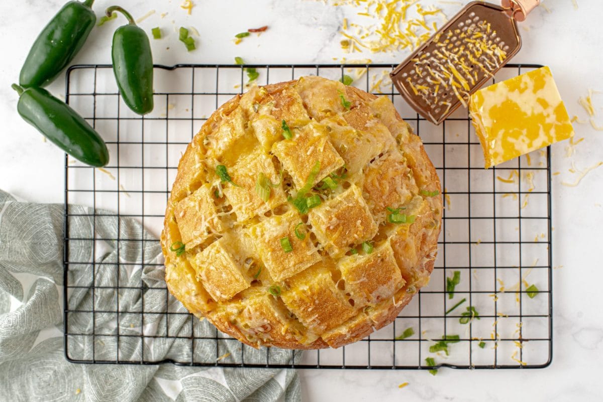 overhead of jalapeno bread with fresh jalapenos and cheese 