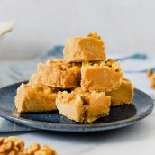 pile of maple walnut fudge on blue plate