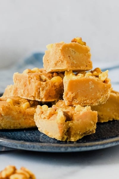 pile of maple walnut fudge on blue plate