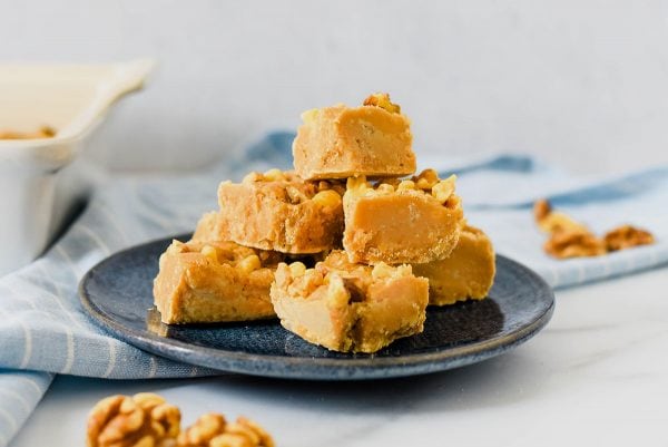 pile of maple walnut fudge on blue plate