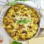 overhead of pesto tortellini in a cooking vessel