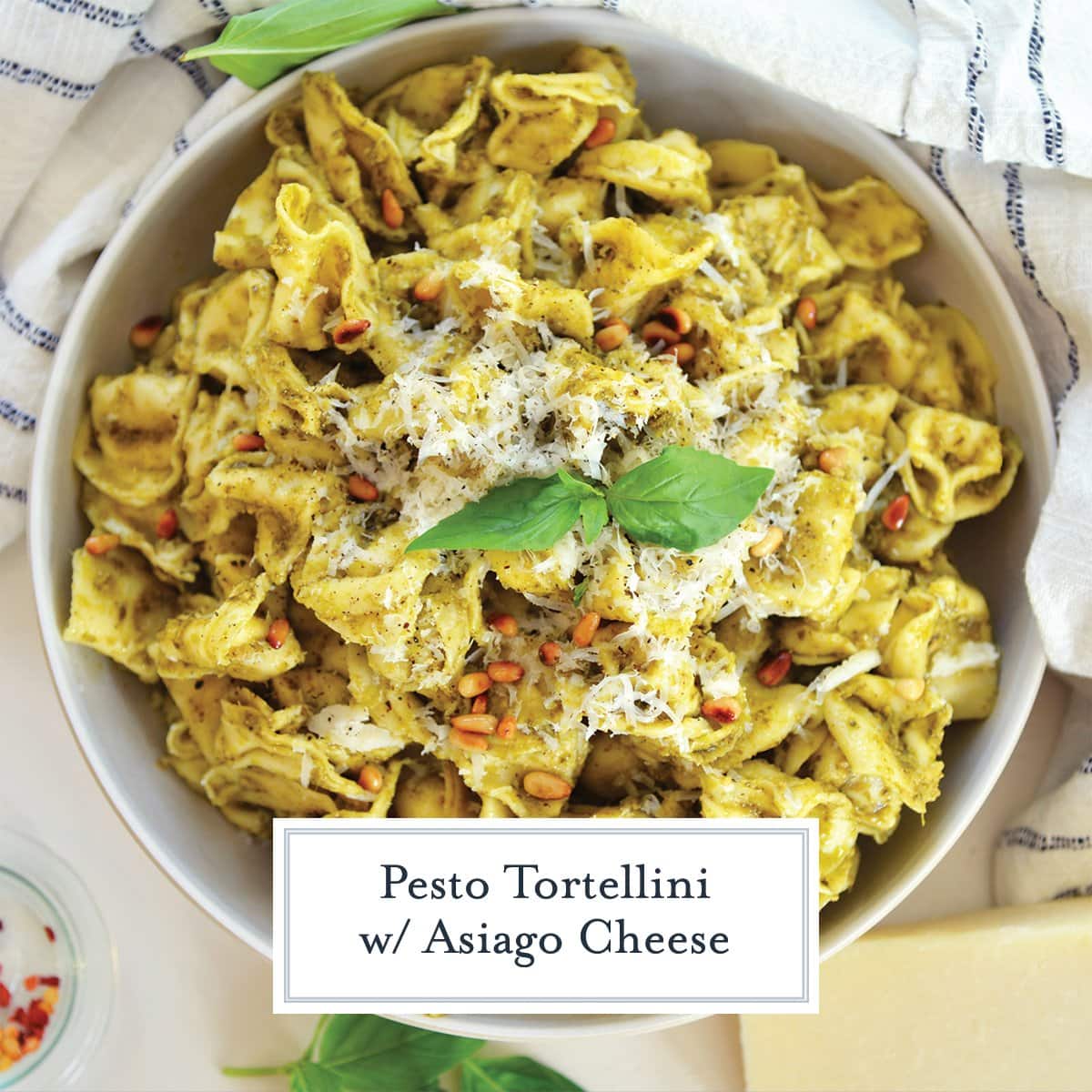 overhead of pesto tortellini with fresh basil and cheese 