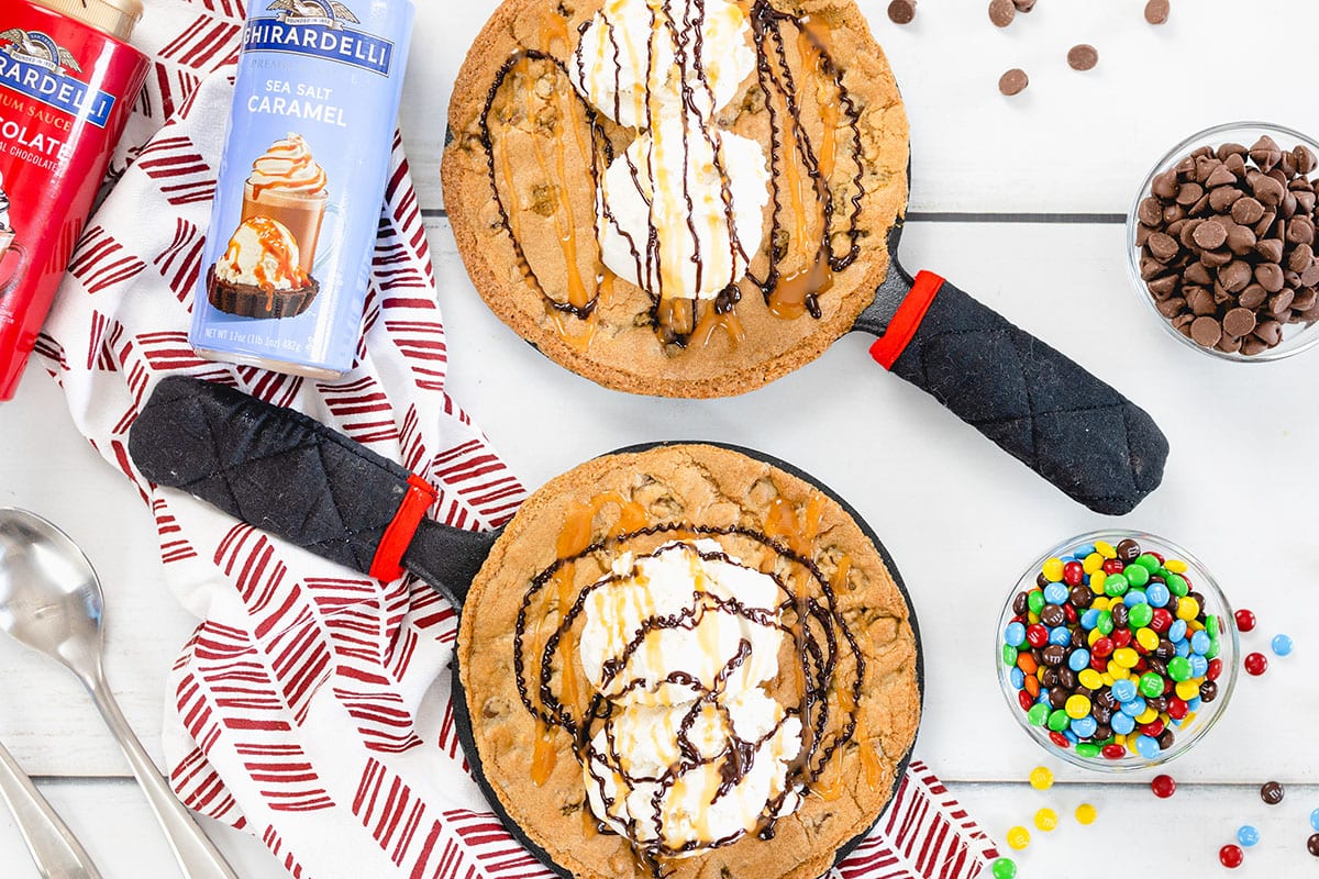 overhead of two skillet cookies with toppings