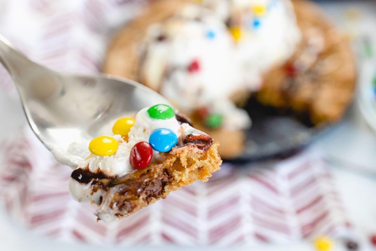 fork holding bite of chocolate chip cookie 