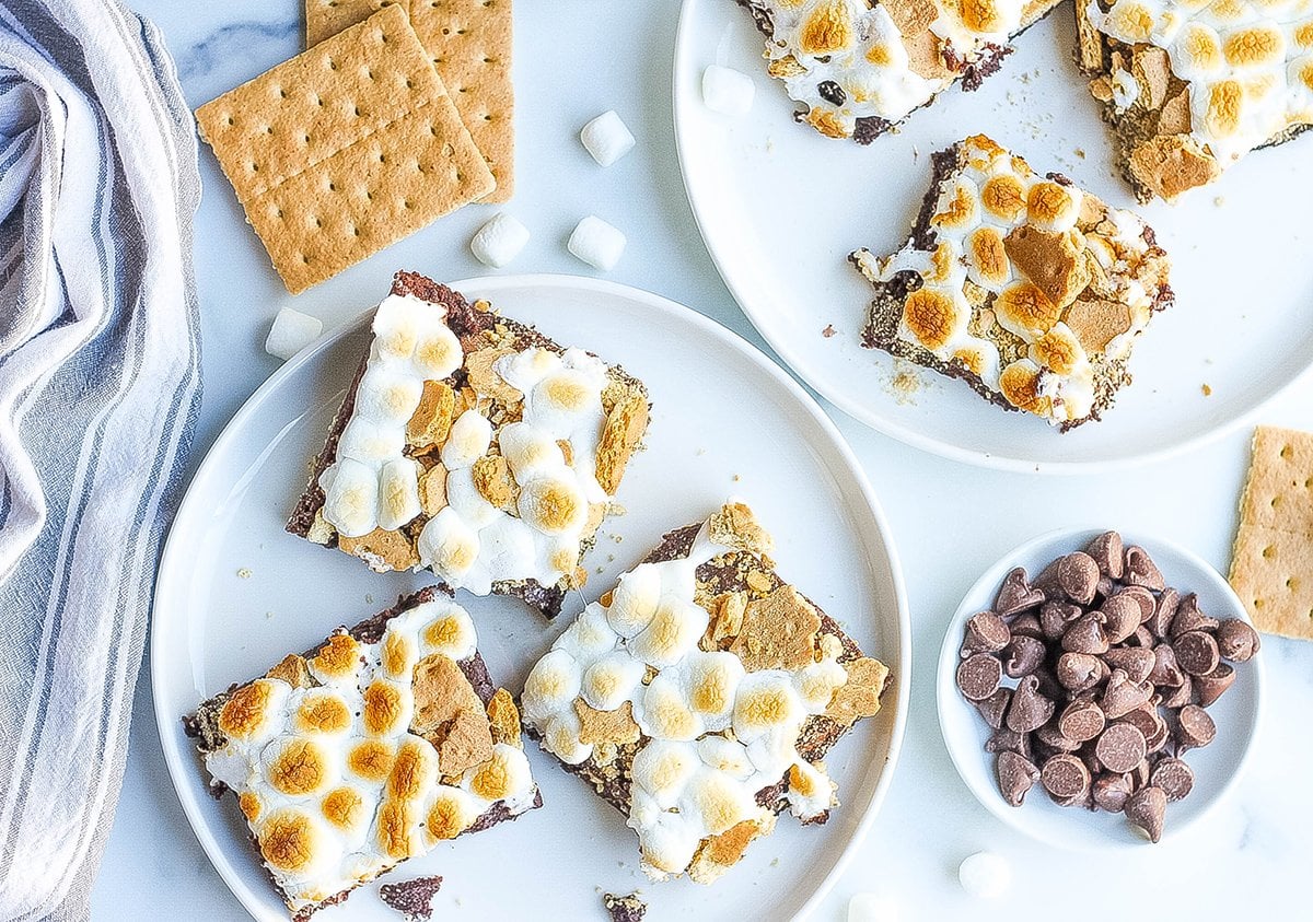 overhead of s'mores brownies being served on white plates 