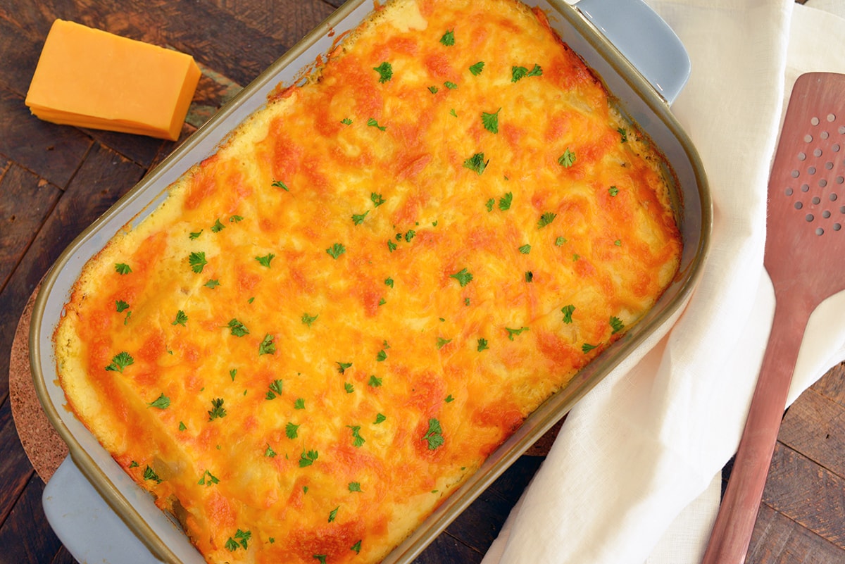 overhead of browned and bubbly potatoes in a casserole dish 