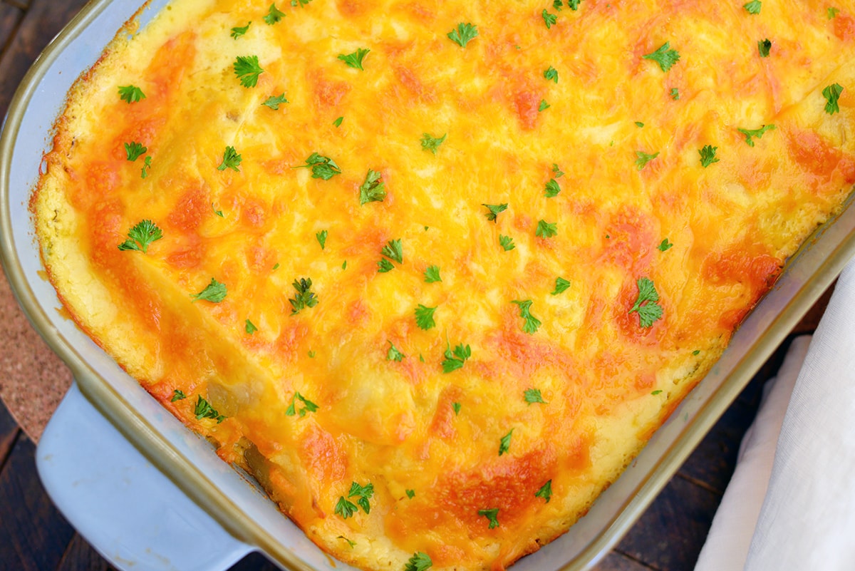 overhead of cheesy au gratin potatoes in a blue casserole dish 