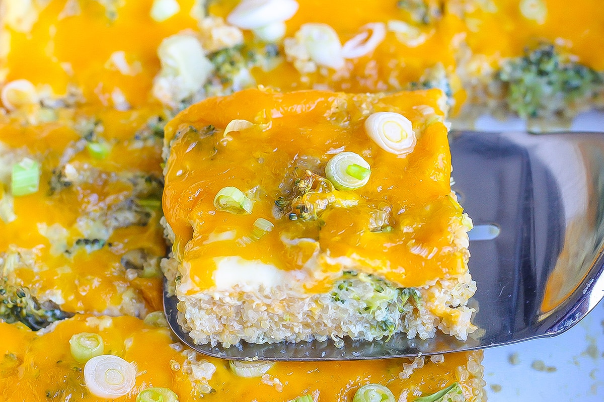 spatula listing a square of quinoa casserole out of a baking dish 