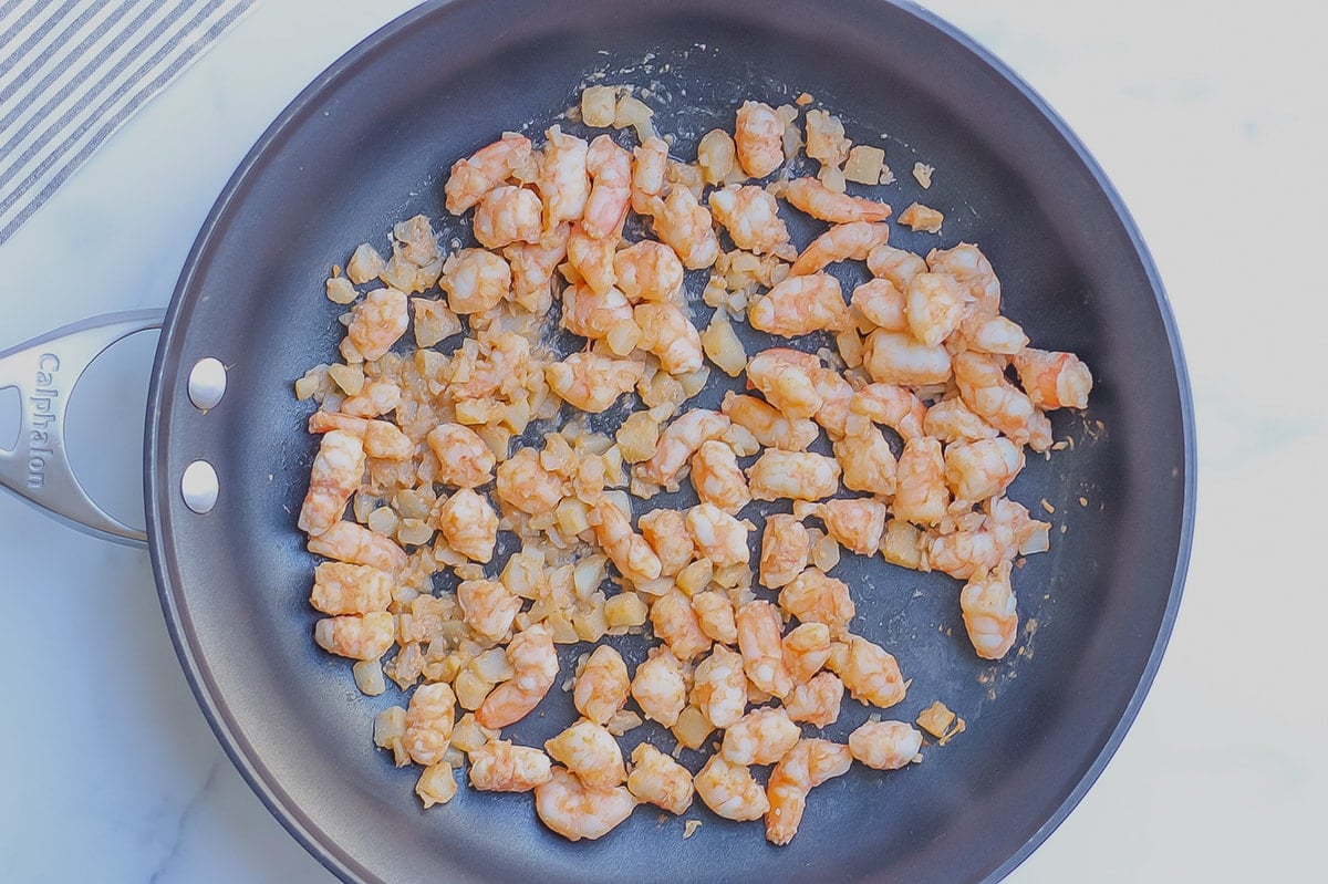 overhead of shrimp and water chestnuts in a skillet 