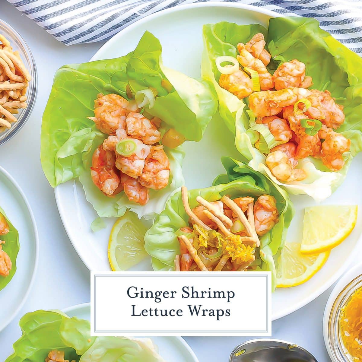overhead of three shrimp lettuce wraps on a plate with lemon wedges