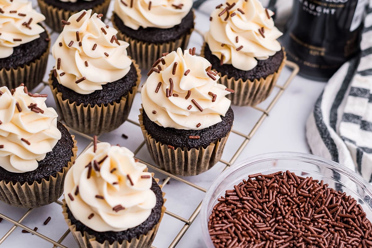 cupcakes on a wire rack with chocolate sprinkles