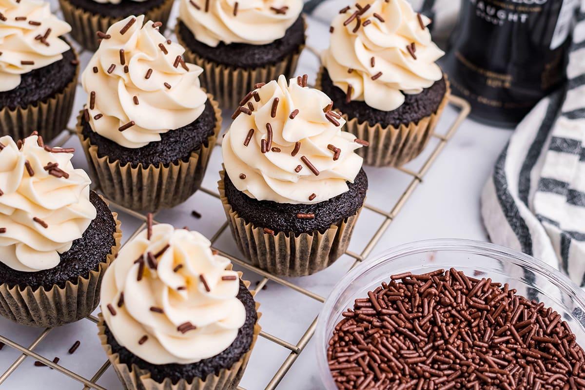 cupcakes on a wire rack with chocolate sprinkles  