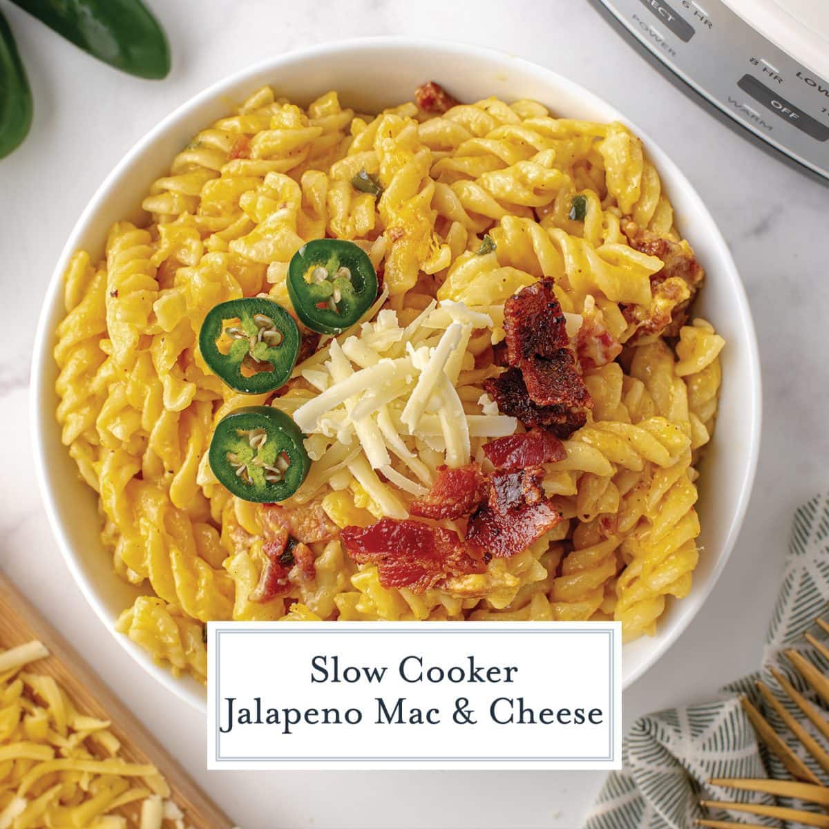 overhead close up of jalapeno mac and cheese in a bowl with jalapeno slices, cheese and bacon