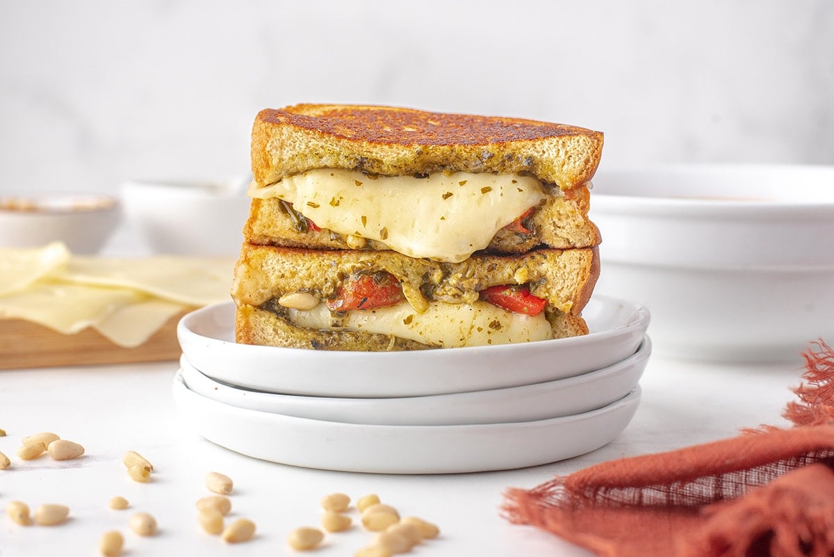 angle view of a pesto grilled cheese sandwich on plates 