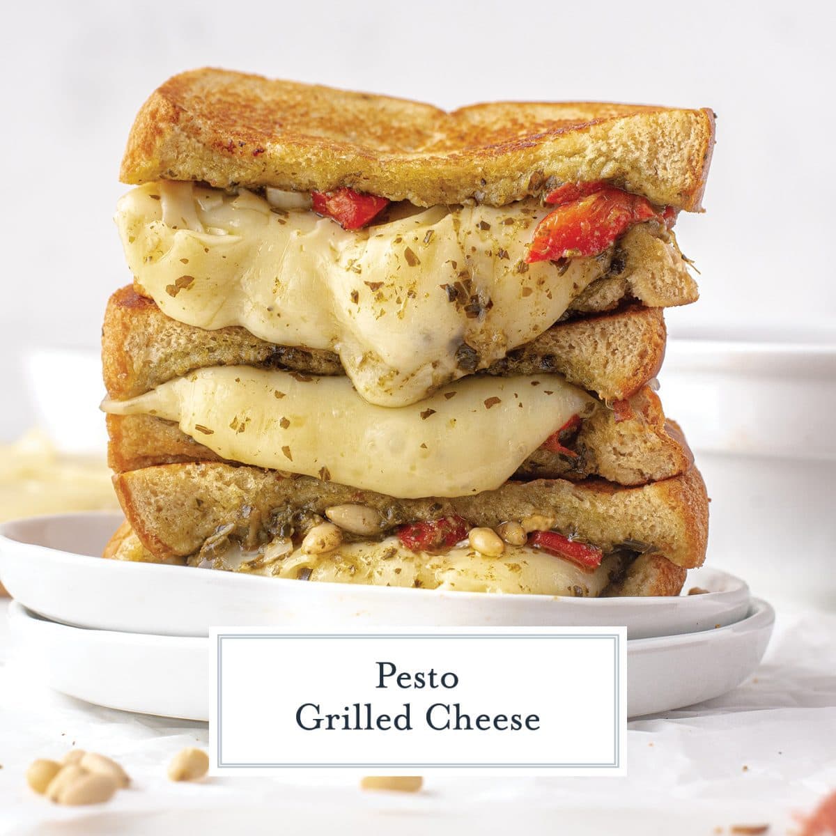 cheese melting down a sandwich with pesto