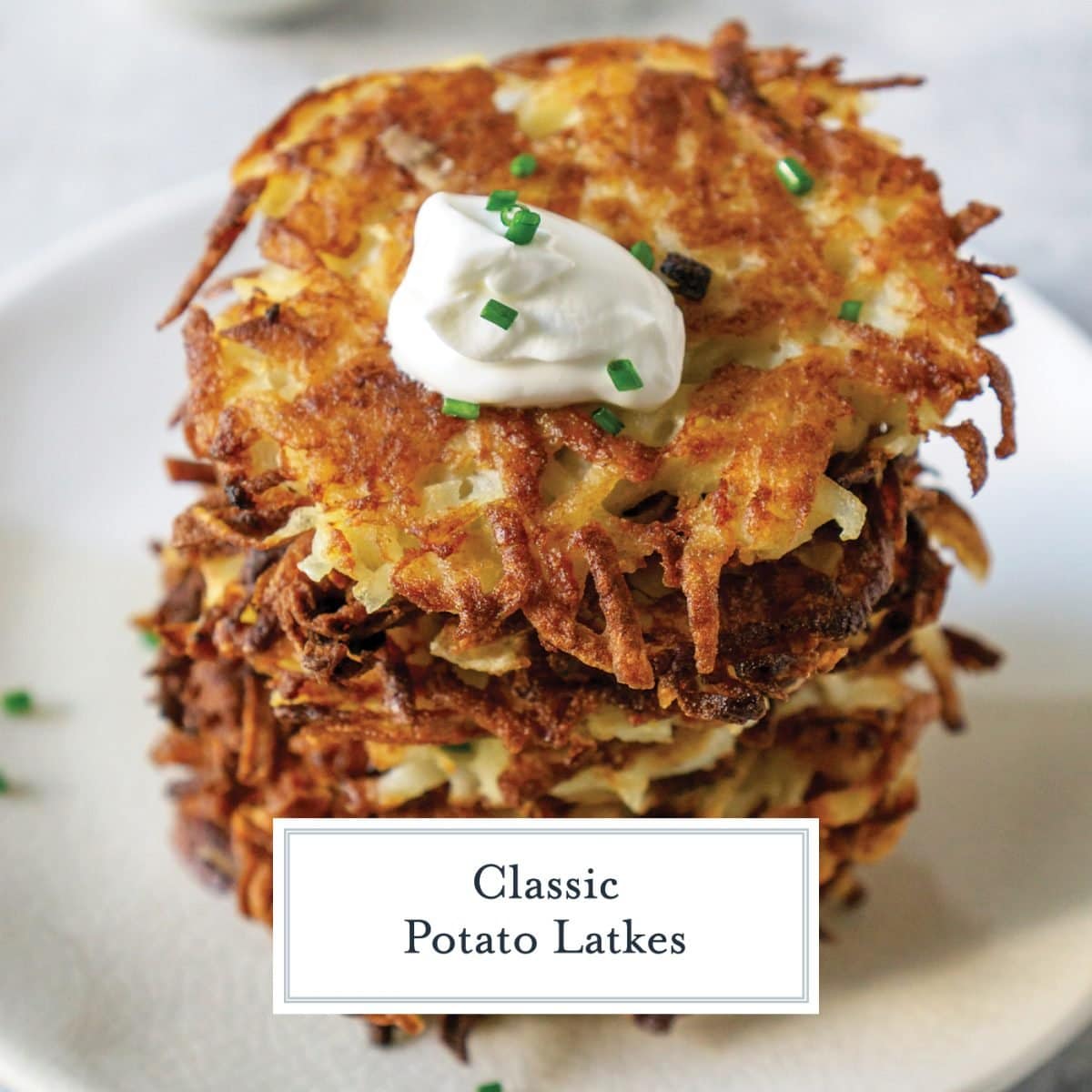 angle stack of potato latkes with sour cream and chives