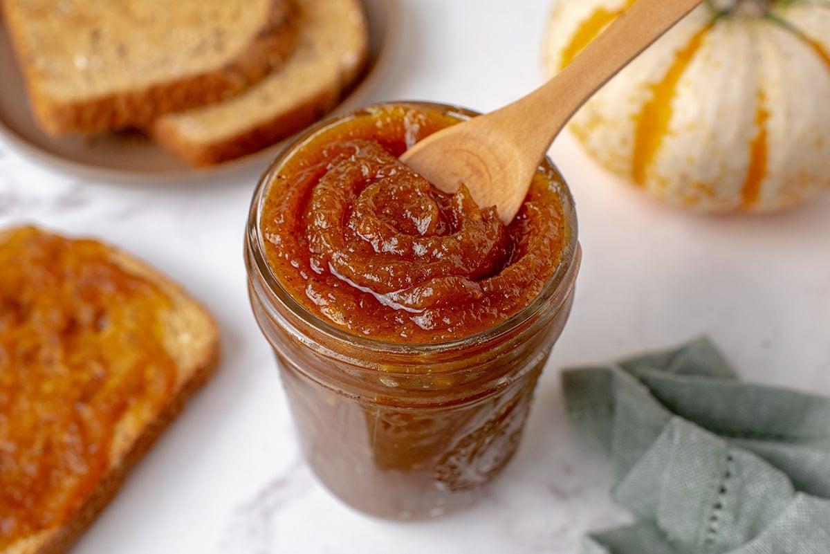 wood spoon in pumpkin butter 