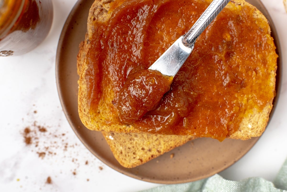 knife spreading butter on toast 