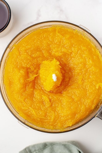 overhead of pumpkin puree in a mini food porcessor