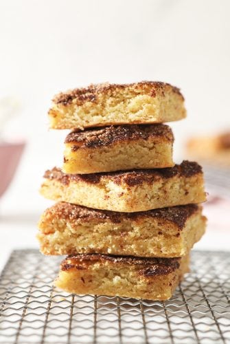 stack of snickerdoodle bars on a cooling rack