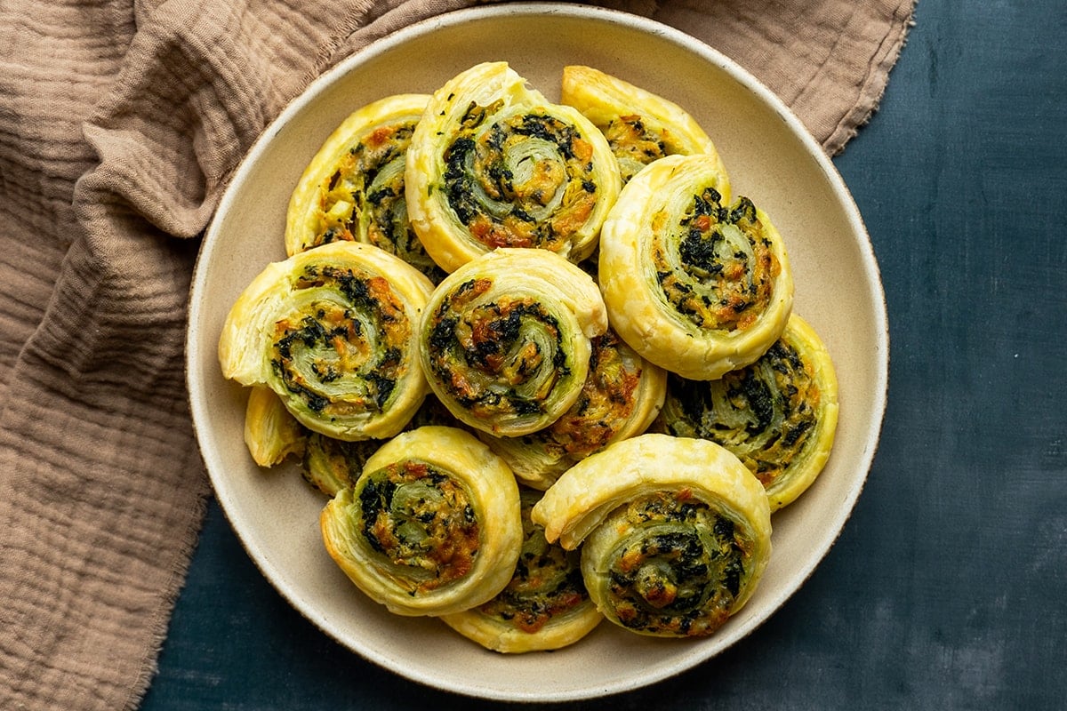 overhead of plate of spinach and artichoke pinwheels 
