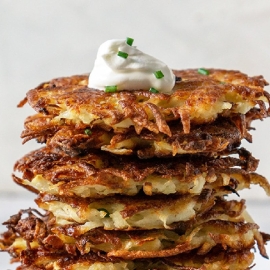 close up of potato latkes with sour cream