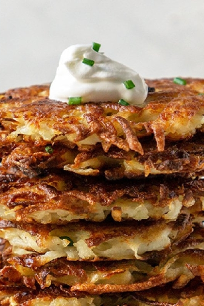 close up of potato latkes with sour cream