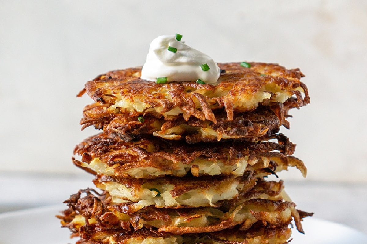 close up of potato latkes with sour cream