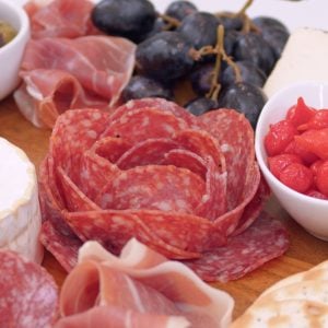 close up of a meat flower on a charcuterie board