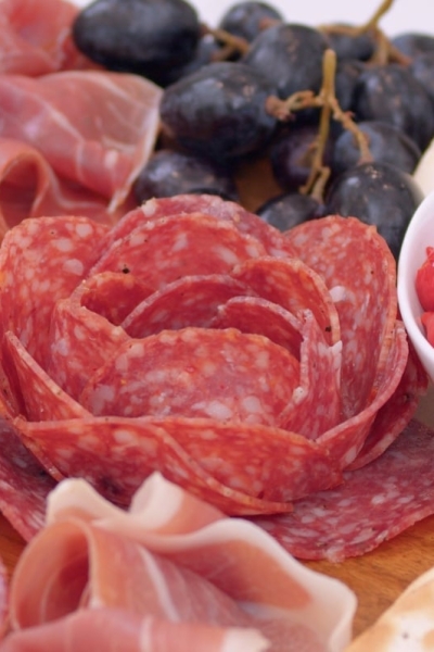 close up of a meat flower on a charcuterie board