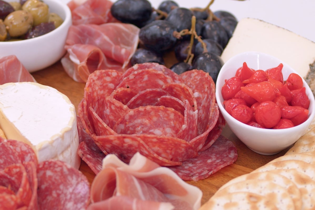 close up of a meat flower on a charcuterie board