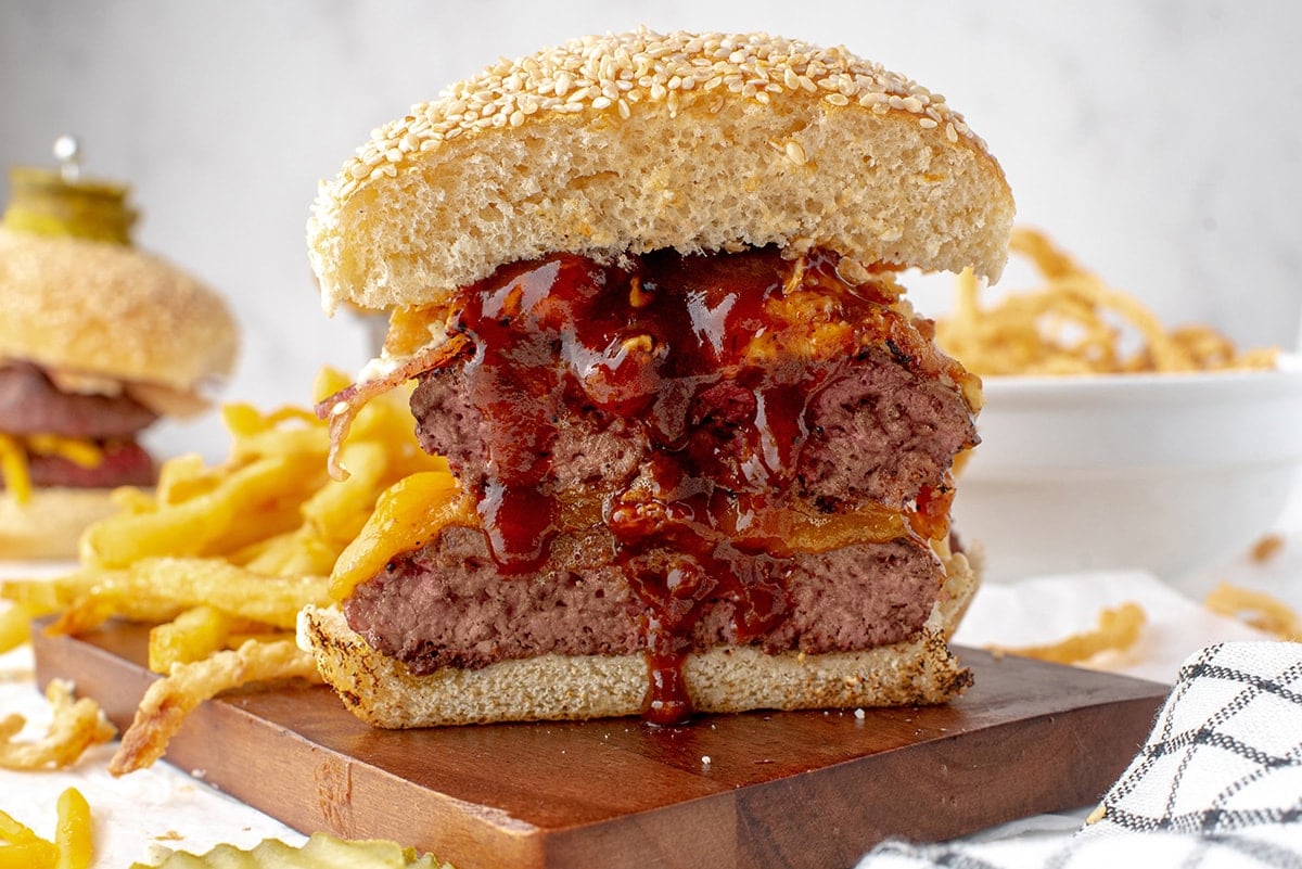 cowboy burger cut in half with BBQ sauce melting down the inside 