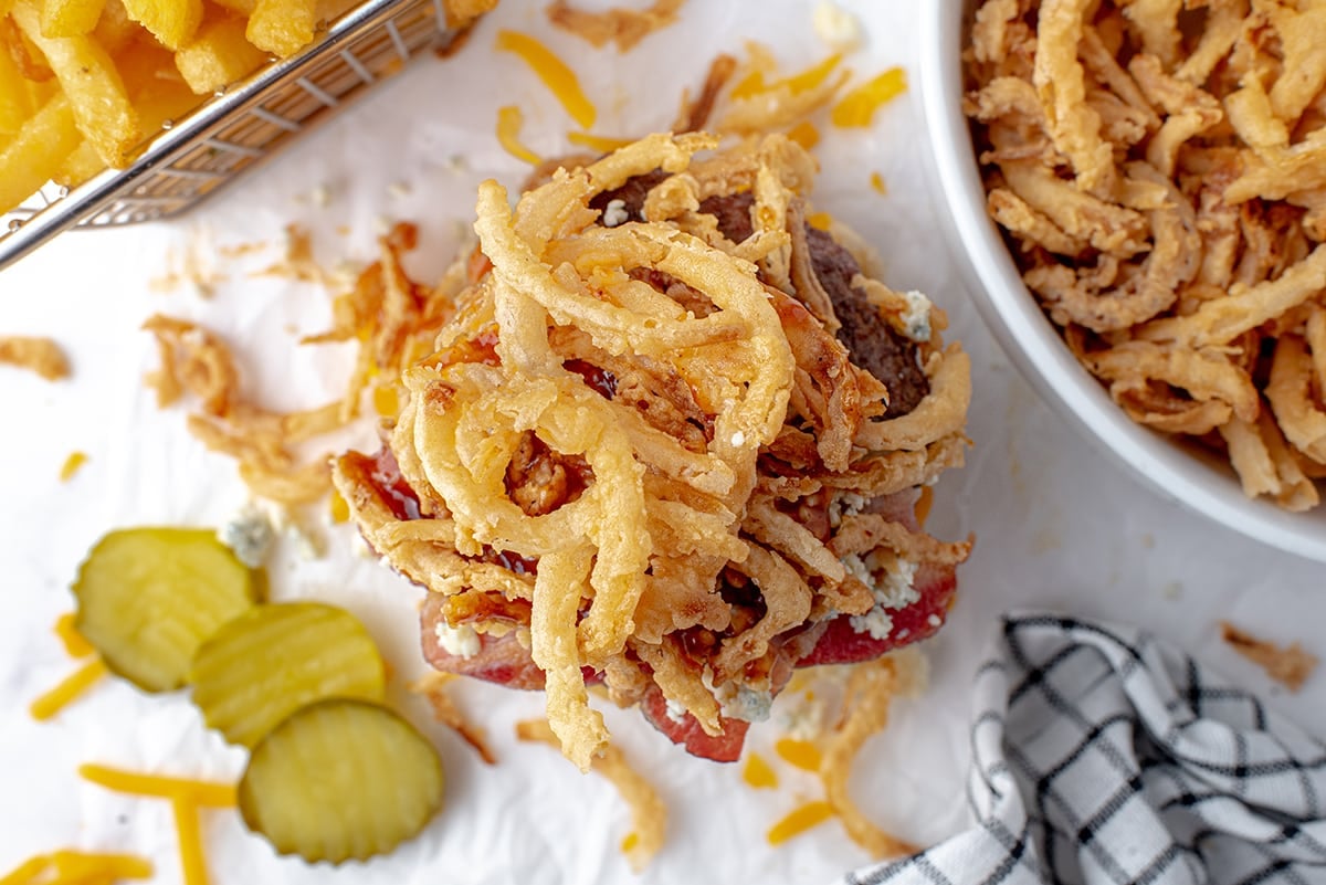 crispy onion straws on a burger