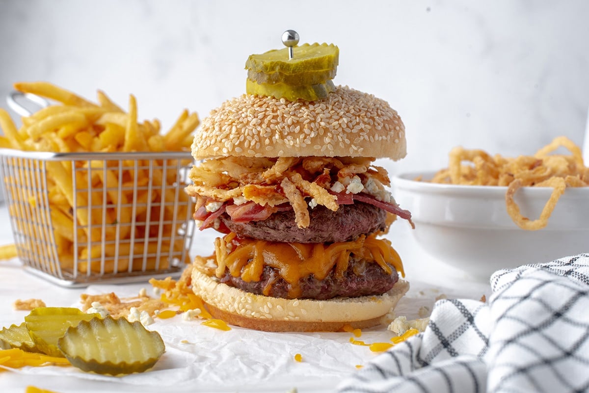 burger with crispy onions, cheese, bacon and pickles 